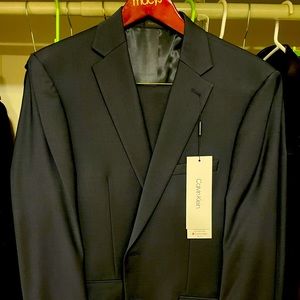 Brand new midnight blue Calvin Klein suit in 42Reg and trousers in 38W x 32L